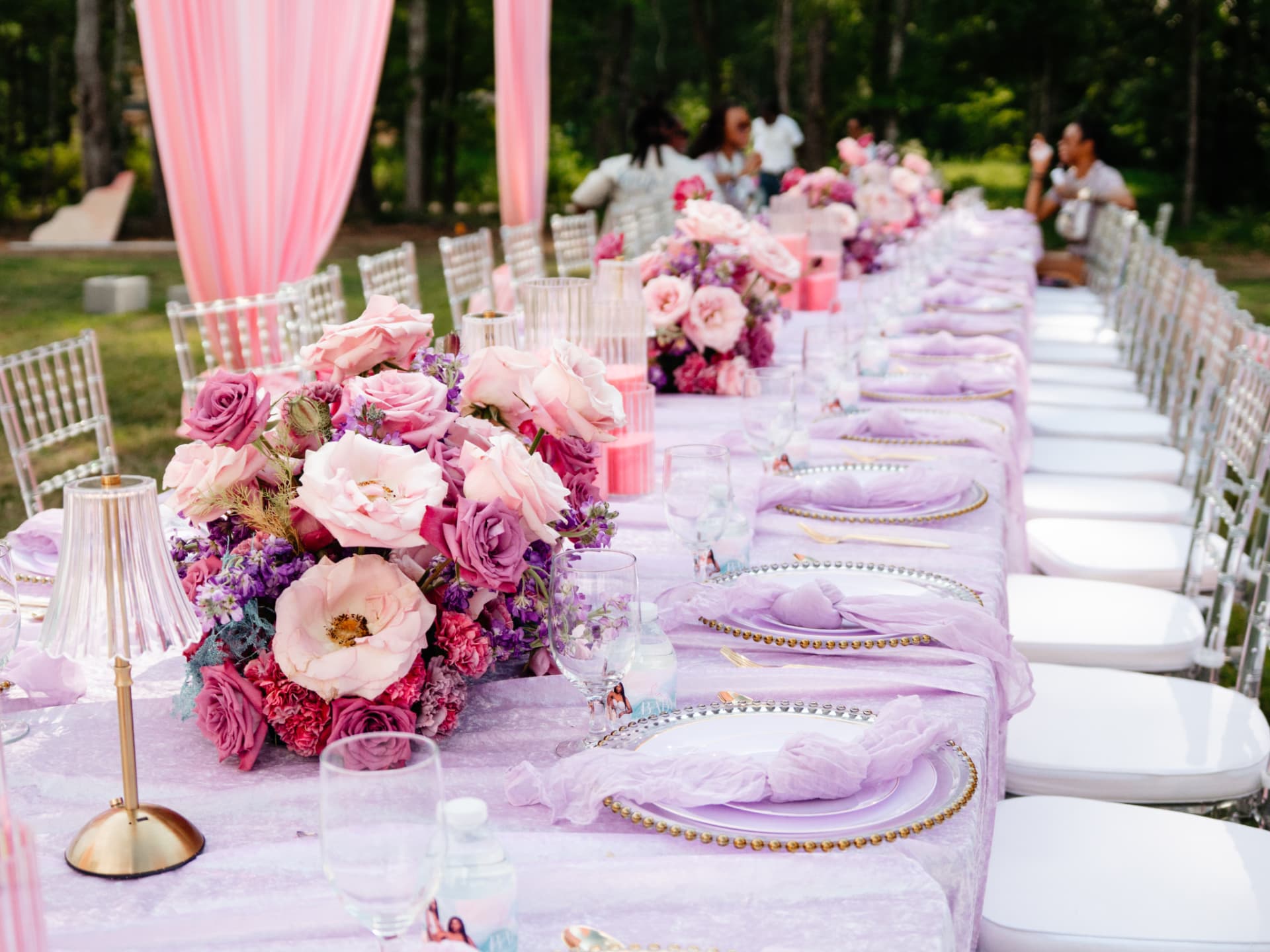 Long banquet table with pink and purple florals